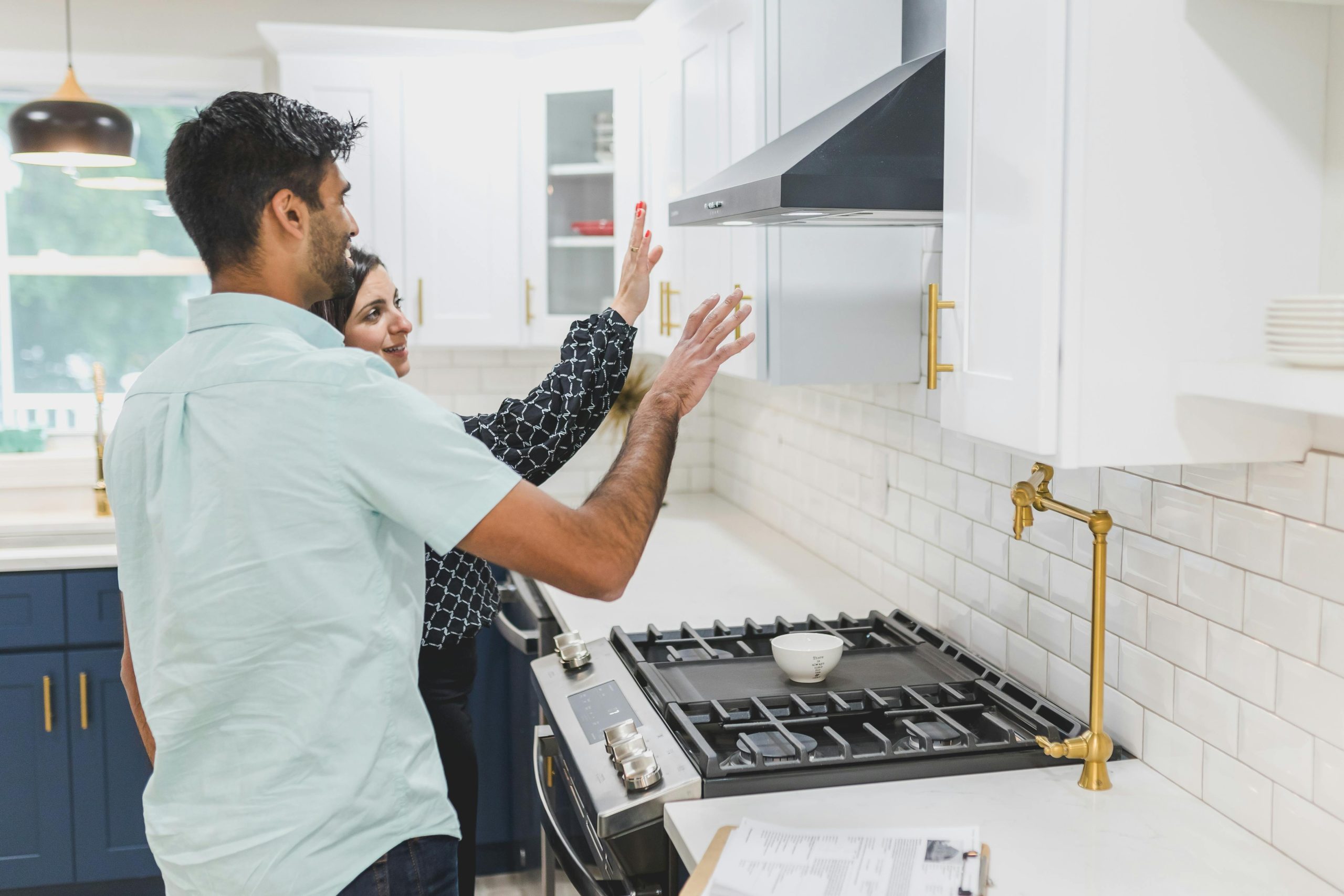 couple in their kitchen, discussing renovation plans